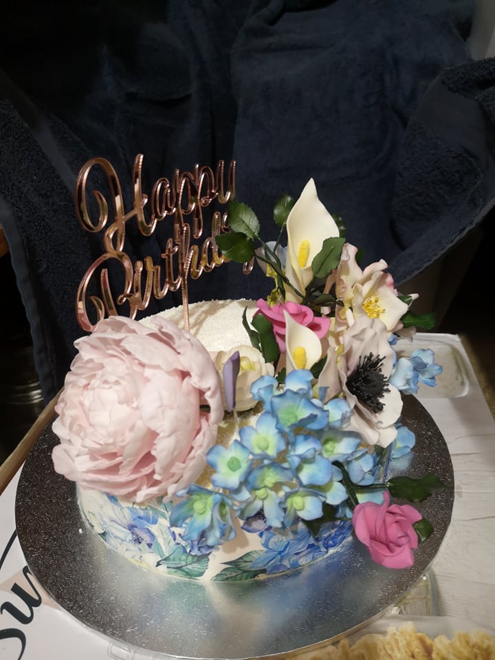 Single tier cake covered in hand crafted sugar flowers made for my mother's birthday