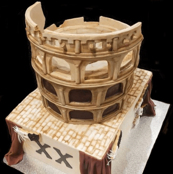 Specialty Coliseum and theatre cake combining two themes in two layers, with cookie masks and fondant curtains and fondant roman coliseum -  custom made by Embellished Food Art, Lower Hutt, Wellington cake decorator