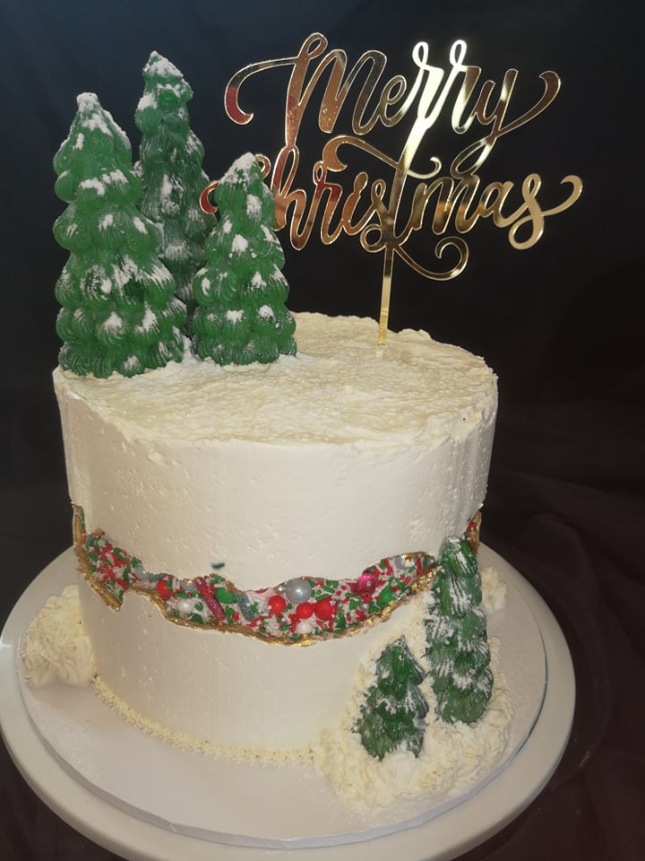White Christmas faultline cake with green buttercream Christmas trees and Christmas baubles sprinkles