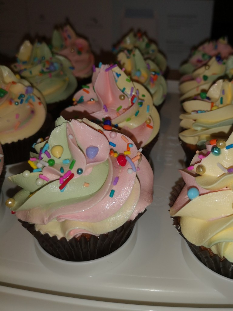 Delicious and pretty rainbow swirl cupcakes, pastel colours with rainbow sprinkles - by Embellished Food Art, Lower Hutt, Wellington cake decorator