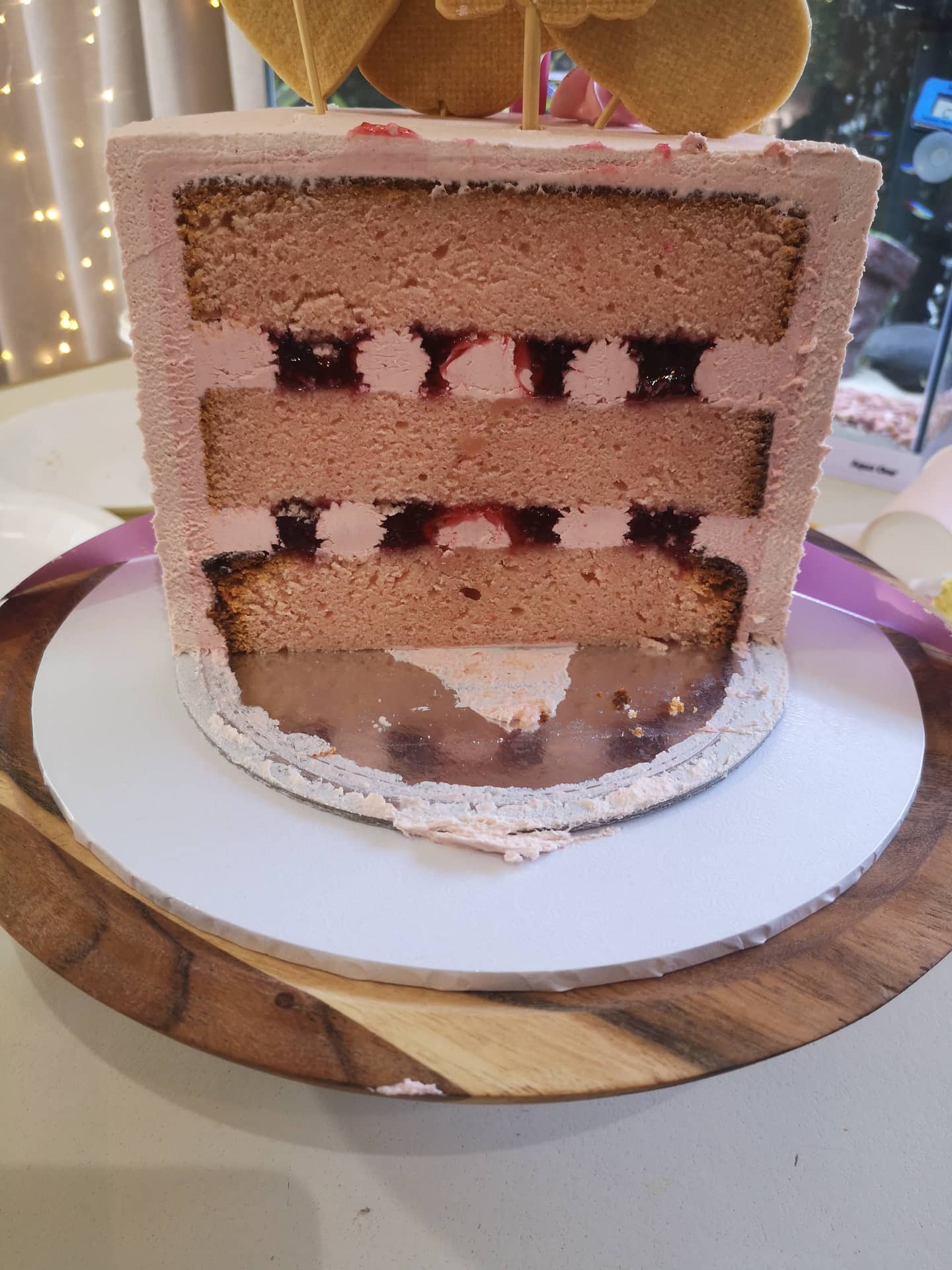 Cut cake showing how good it is inside, with buttercream and raspberry coulis