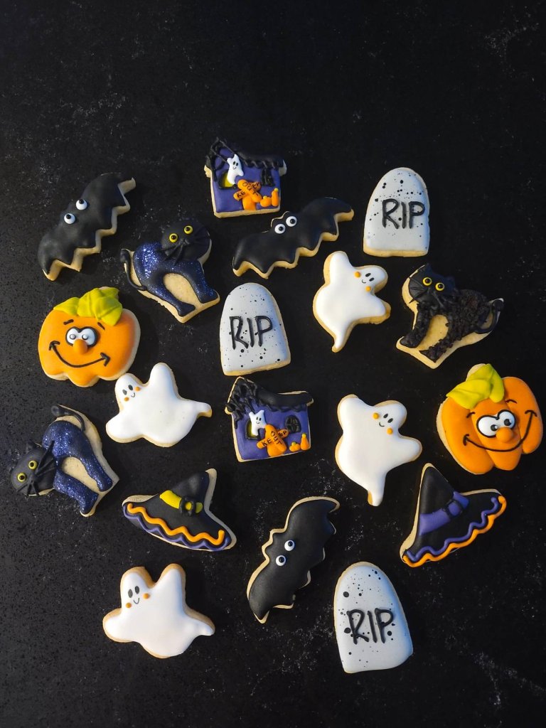 Halloween cookies pumpkin, cat, tombstone, ghost, haunted house, bat, witch's hat - designed and custom made by Embellished Food Art, Lower Hutt, Wellington cake decorating