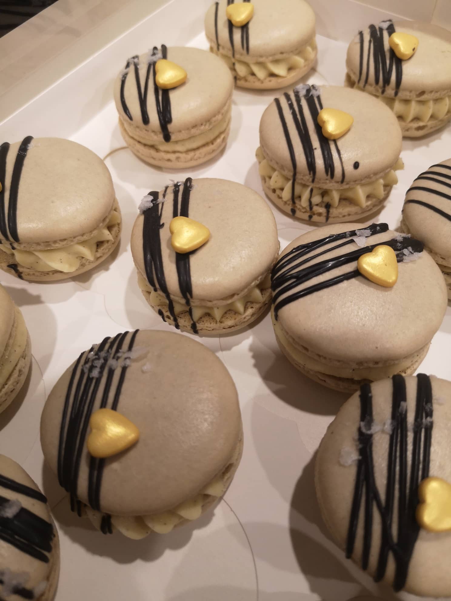 Coffee Macarons with chocolate drizzle and gold hearts