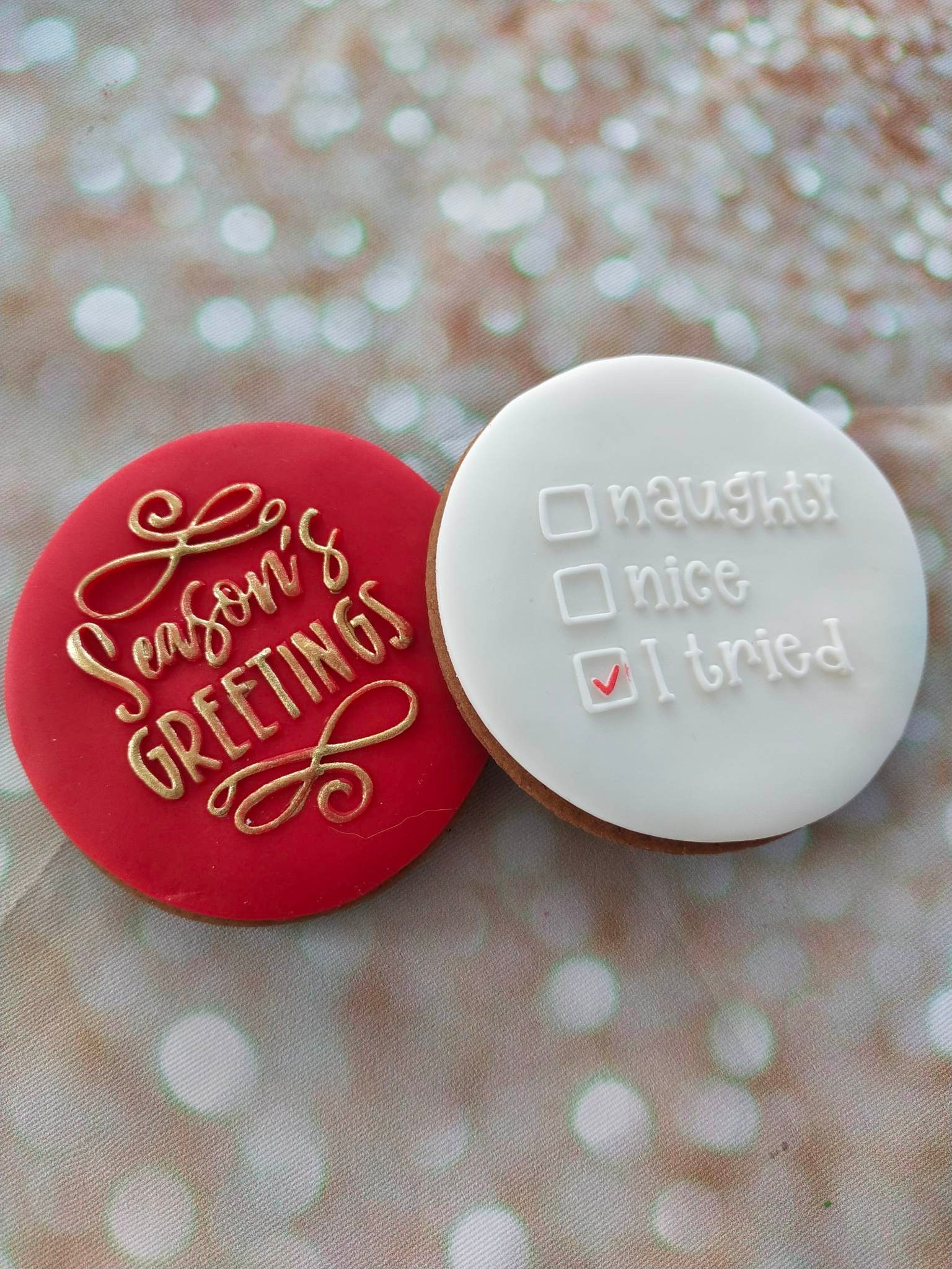 Custom made Christmas cookie set with embossed text of seasons greetings and naughty, nice and I tried tick boxes